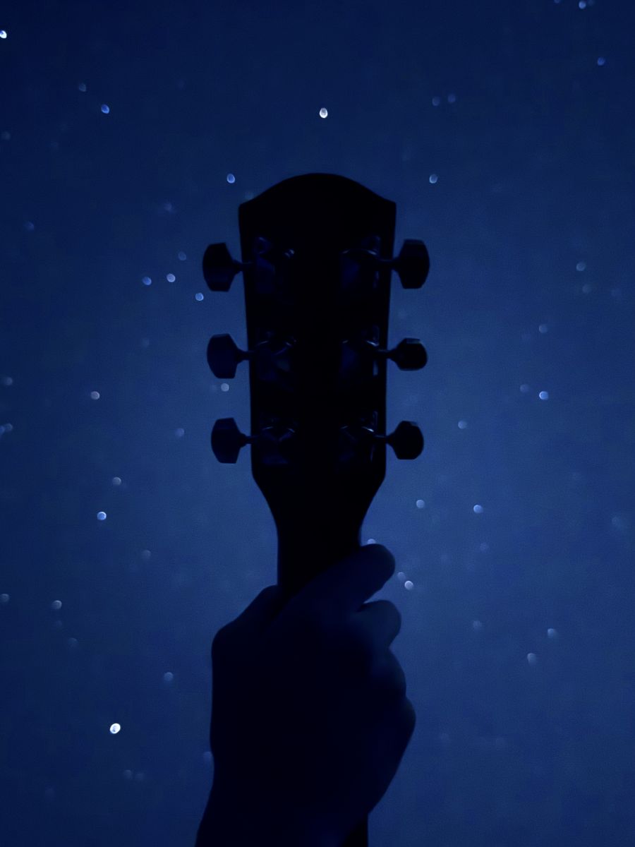 Guitar headstock against the stars